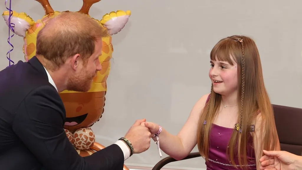 Prince Harry is given award by inspirational girl on solo UK visit