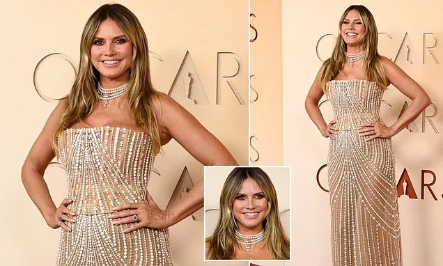 Heidi Klum models a see-through gold gown at the Oscars