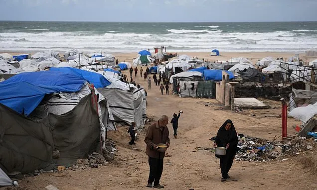 Freezing rain floods Gaza camps and leaves displaced Palestinians...