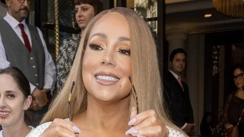 Mariah Carey sizzles in white knit dress as she departs London hotel