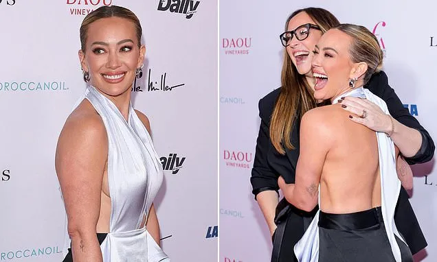 Hilary Duff flashes sideboob while bra-free in a daring gown