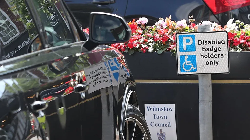 Wayne Rooney leaves his Audi 4x4 in a disabled parking zone