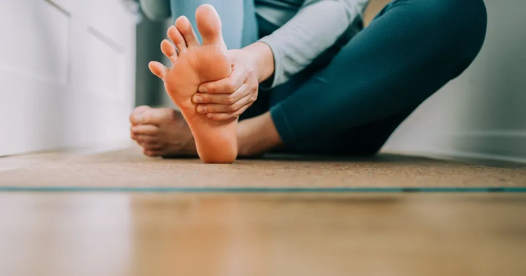 What Having Flat Feet Really Means For Your Health, According To Experts