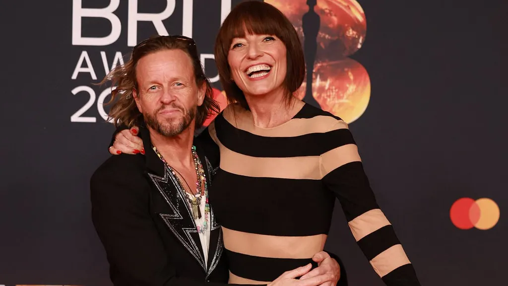 Davina McCall cosies up to her beloved husband  at the BRITs