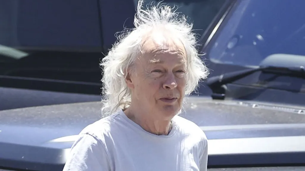 Iconic Aussie rocker cuts a casual figure as he steps out in Sydney