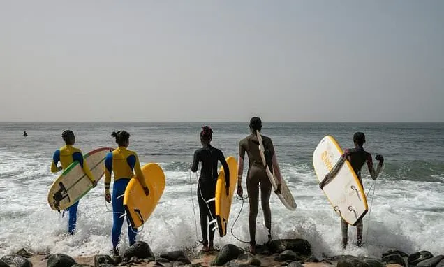 In Dakar fishing village, surfing entices girls back to school