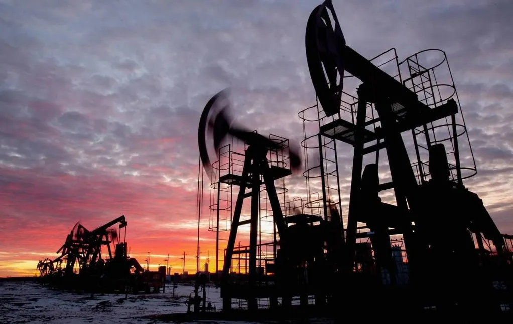 Oil prices settle lower as US dollar surges