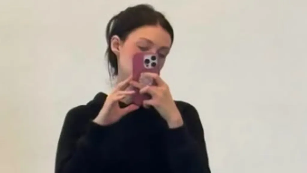 Nicola Peltz poses in black gym shorts as she does the splits