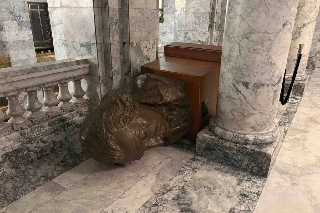 Hammer-wielding intruder sets fire to flag in Washington capitol