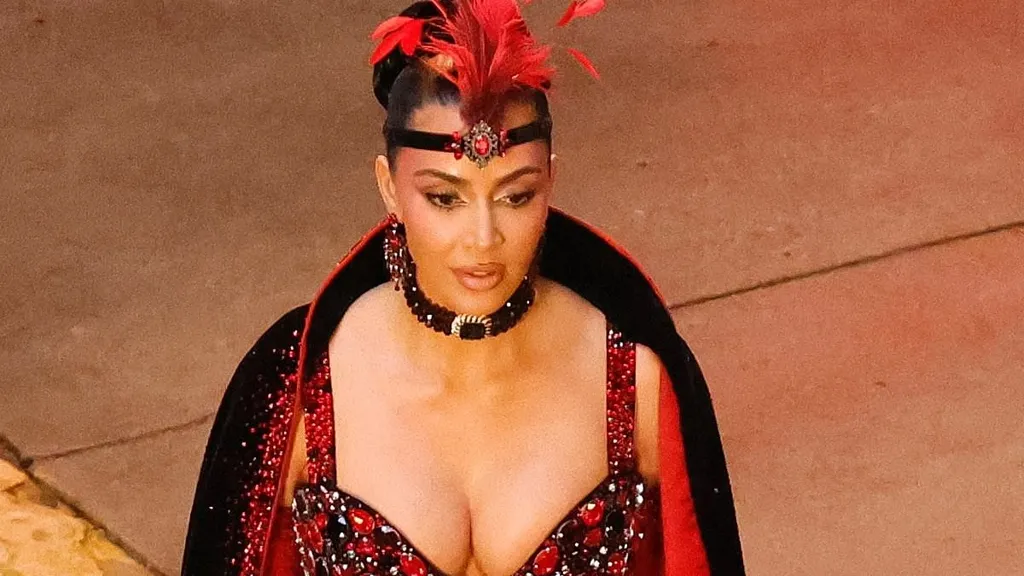 Kim Kardashian wows in a showgirl costume on set with Will Ferrell