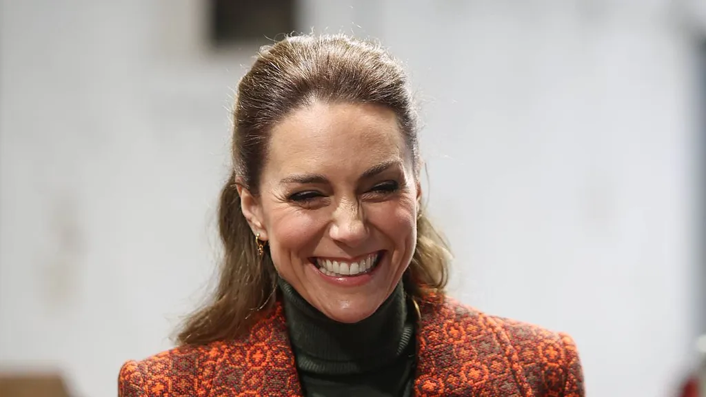 Kate stuns in bespoke tapestry coat and Victoria Beckham trousers