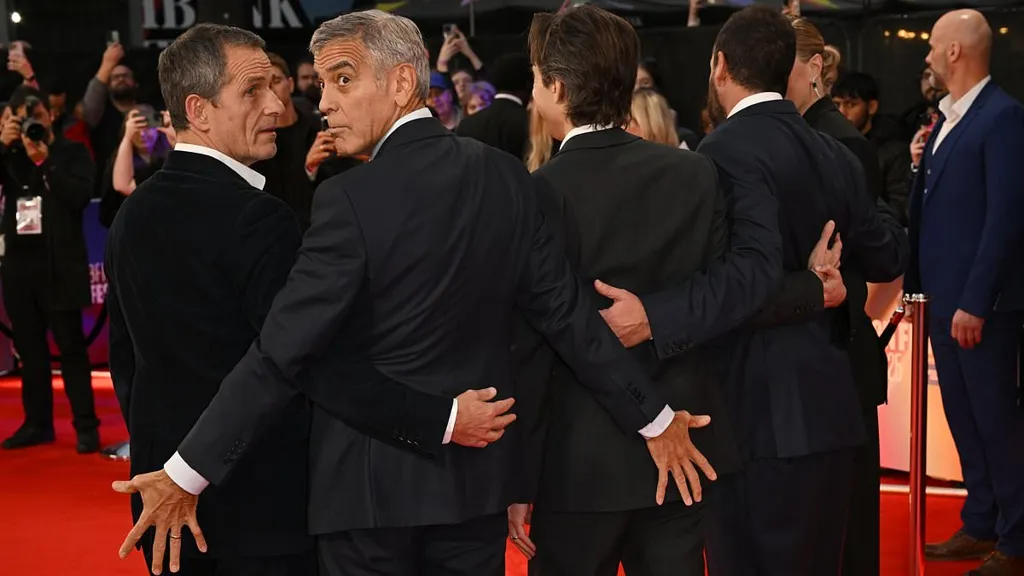 George Clooney puts on cheeky display with pals at Jay Kelly premiere