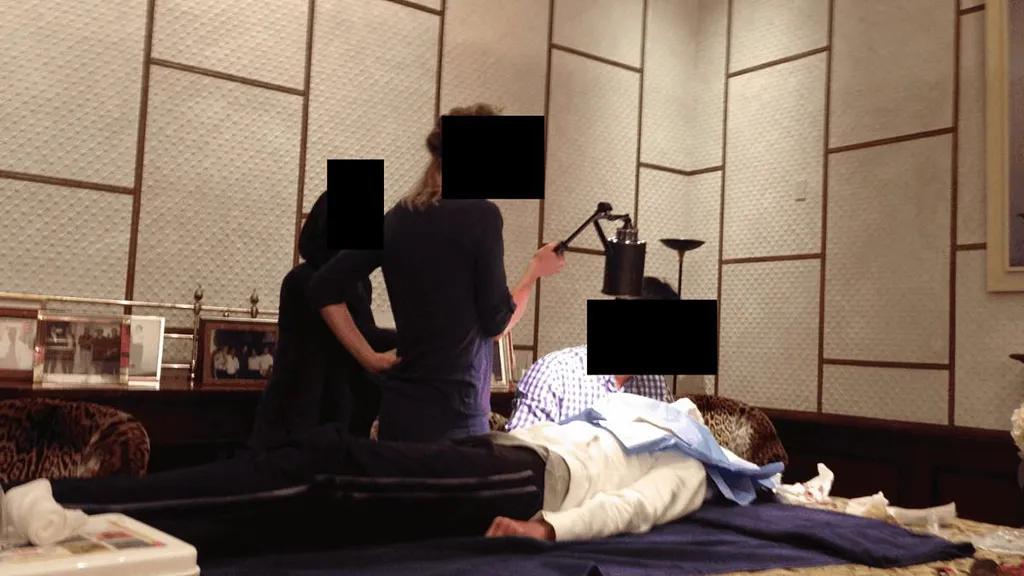 Epstein photo shows doctor giving woman STITCHES on dining room table