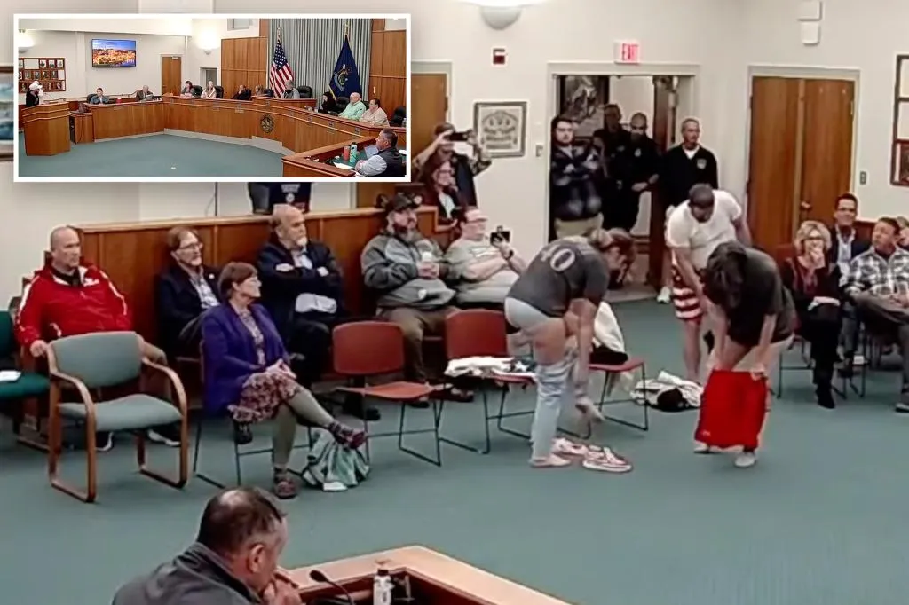 Three activists strip at a Maine school board meeting in protest of...