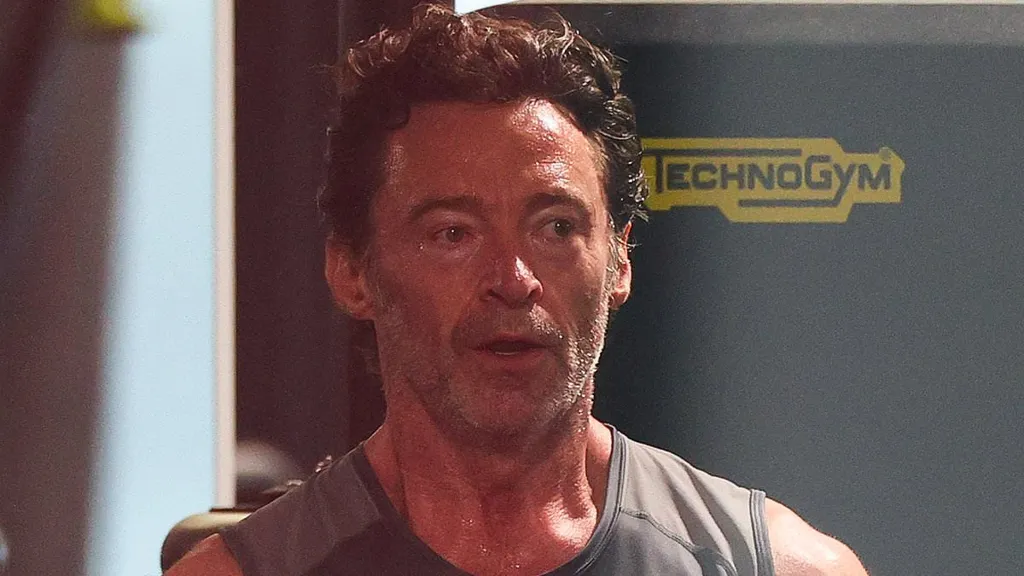 Hugh Jackman shows off his bulging biceps as he completes workout